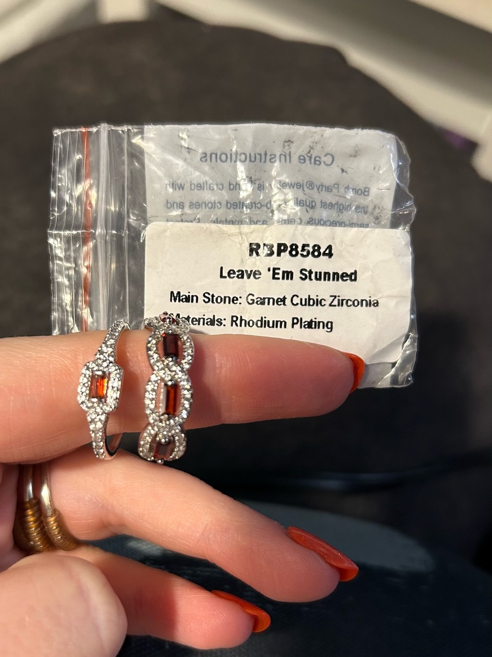 bp Rhodium-Plated Ring with Garnet-Colored CZ Accents